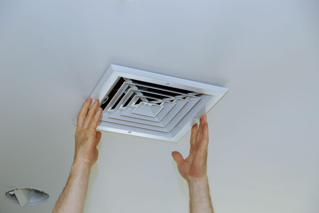 Technician installing bathroom vent in St Peters
